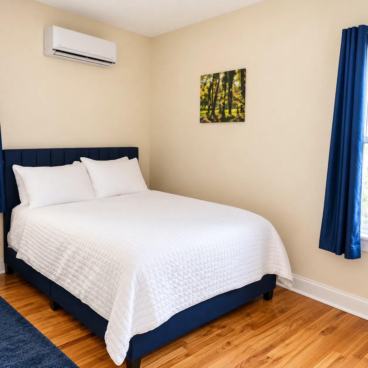 OoohLaLa@Newark — Deep blue accents add character to a comfortable, furnished sleeping space.